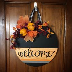 a welcome sign hanging on a wooden door