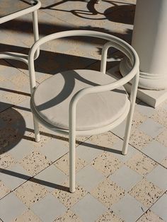 a white chair sitting on top of a tiled floor