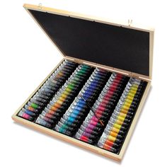 a wooden box filled with lots of different colored crayons in it's lid