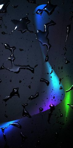 rain drops on the window with colorful lights in the backgroung and black background