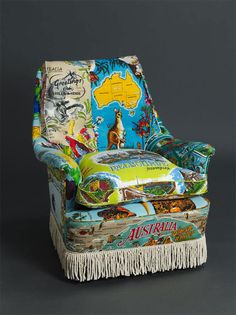 an upholstered chair with colorful fabric and fringes