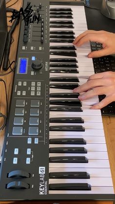 a person playing an electronic keyboard on a table