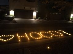 the word hope spelled out in front of a house at night with lights on it