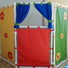 an indoor play area with curtains and flowers on it