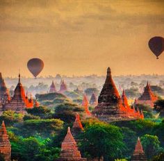 hot air balloons flying over the temples in bagan