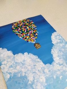 a painting of a hot air balloon in the sky with clouds and houses on it