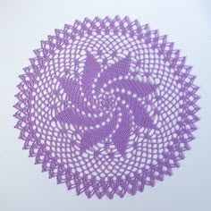 a purple doily is shown on a white surface