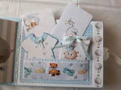 a baby's album with teddy bears and other items on it, including cards