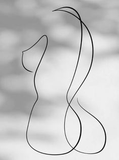 a black and white photo of a woman's head with long hair in the wind