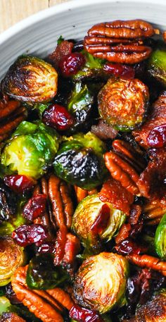 brussel sprouts with pecans and cranberries in a white bowl