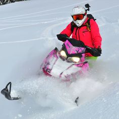 a person riding a snowmobile in the snow