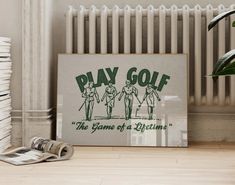 a newspaper sitting on top of a wooden floor next to a poster with the words pay golf