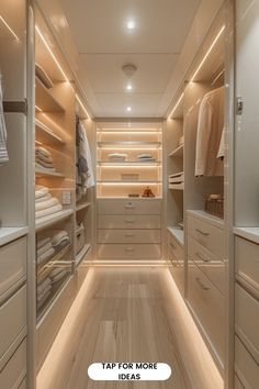 an empty walk - in closet with white drawers and lights on the ceiling is lit by recessed lighting