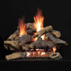 a fireplace with logs and flames burning in it