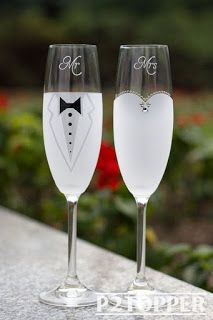 two wine glasses with the names mr and mrs written on one glass, sitting next to each other