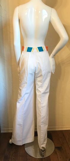 "Wow....1970's Mod pants suit - tagged Strawberry Plant California by Dorothy Schoelen. Here is a great set In a cotton blend broadcloth fabric. The jacket has the bright stripes in an open style with short cuffed Sleeves, patch pockets and has the contrasting top stitching. The pants are a high waist wide leg style and have the stripe waistband and orange contrasting top stitching with a front nylon zipper. Both in great condition. Tagged a size 7/8. measurements lying flat: Jacket - Bust 19\", Tailored Cotton Pants For Spring, Retro Stretch Cotton Pants, Retro Cotton Bottoms For Workwear, Retro Fitted Cotton Pants, White Cotton Retro Bottoms, Retro Cotton Pants For Work, Retro Cotton Pants With Belt Loops, White Retro Stretch Pants, Retro White Stretch Pants