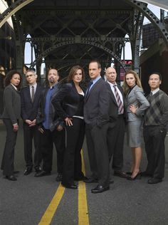 a group of people in suits and ties posing for a photo with the words law & order special victims unit