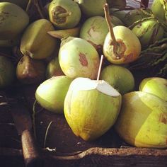 a pile of coconuts sitting next to each other on top of a wooden table