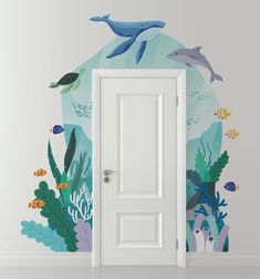 an open door in front of a wall with dolphins and corals