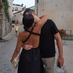 a man and woman kissing on the street