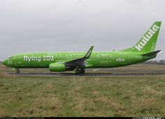 a large green airplane is on the runway