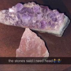 two large rocks sitting next to each other on top of a wooden table with the caption, the stones said i need heal