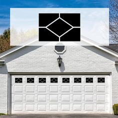 a white garage with black windows and an image of a light on the side of it