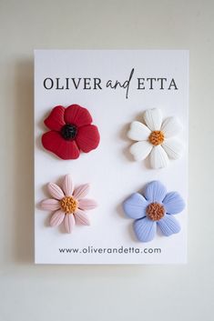 three different colored flowers on a white card with the words oliver and etta