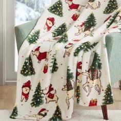 a christmas themed blanket on a chair in front of a window