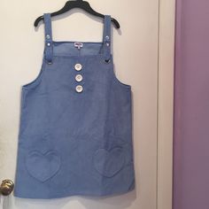 Brand New Blue Heart Pinafore Dress. Never Worn.Looks Like Corduroy But Is Actually Cotton. Has 3 Buttons Down The Front And Heart Pockets. Straps Can Be Adjusted.Says Small But Can Probably Fit A Medium. Cute Blue Dress With Pockets, Cute Sleeveless Cotton Pinafore Dress, Casual Blue Sleeveless Pinafore Dress, Blue Sleeveless Casual Pinafore Dress, Pinafore Apron Heart's Desire Clothing, Blue Fitted Sleeveless Pinafore Dress, Blue Cotton Pinafore Dress With Pockets, Pink Cotton Cute Pinafore Dress, Spring Blue Denim Pinafore Dress