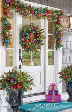 christmas wreaths on the front door with presents