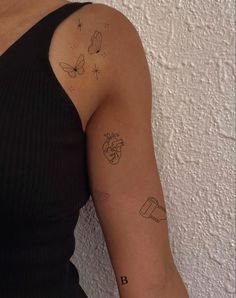 a woman's arm with tattoos on it