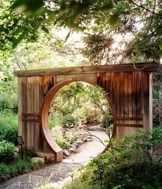 a wooden arch in the middle of a garden