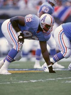 two football players kneel down on the field