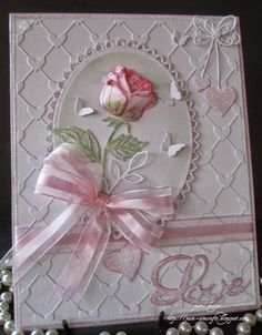 a card with a pink rose on it and pearls around the edges that says d is for love