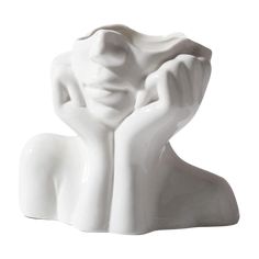 a white ceramic sculpture of a woman holding her head