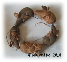 three little mice sitting on top of each other in the shape of a circle,