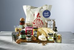 an assortment of food and condiments sitting on a counter top next to a bag