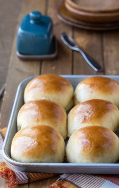 bread rolls in a baking pan on a wooden table