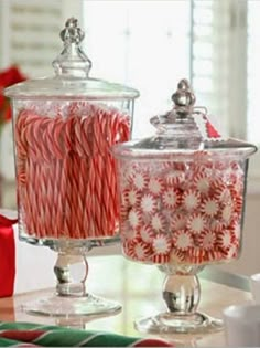 candy canes in glass containers on a table