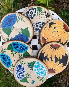 painted wooden slices with flowers on them