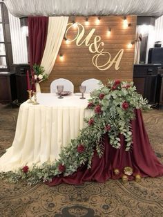 the table is decorated with greenery and candles for an elegant wedding reception at the venue