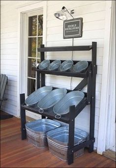 an outdoor kitchen with pots and pans on the outside wall, next to a porch