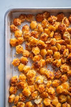 a pan filled with cooked potatoes on top of a table