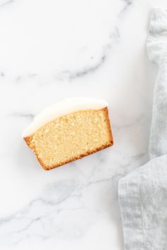 a piece of cake sitting on top of a white counter next to a napkin and fork