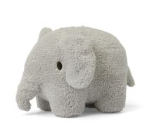 an elephant stuffed animal sitting on top of a white floor next to a yellow sun