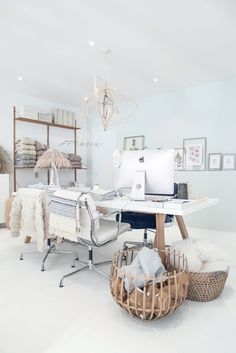 an office with white walls and furniture in it