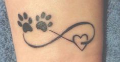 a dog paw and heart tattoo on the ankle