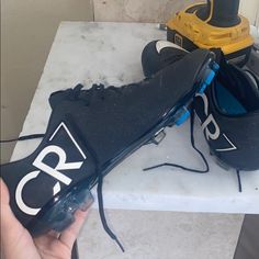 a pair of black and blue shoes sitting on top of a white marble countertop