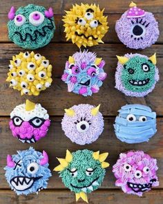 cupcakes decorated to look like monsters with different colors and sizes on top of them